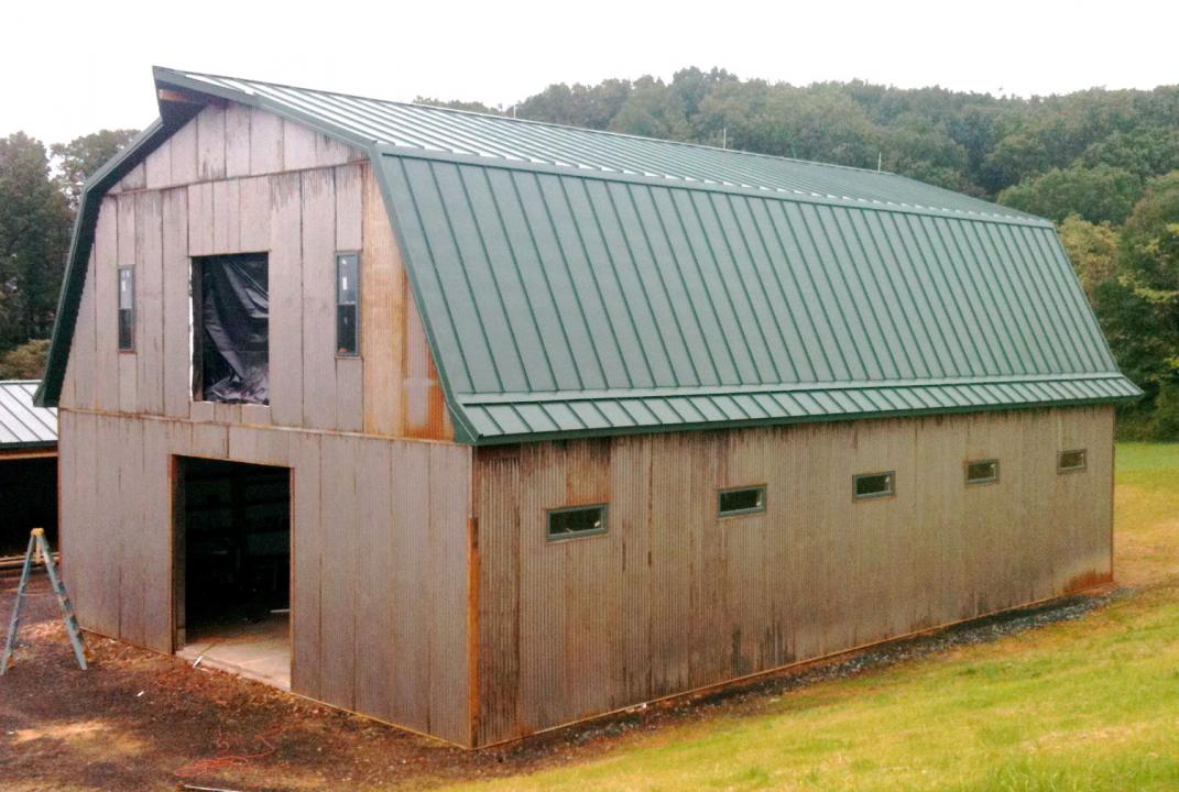 This 2-story pole barn has a Gambrel style roof and measures 40ft wide x 60ft long. The 1st floor has a 12ft ceiling, with the 2nd floor ceiling being 14ft at its highest point.  Features: -Designed to accommodate five 12ft x 12ft horse stalls, with room for a wash bay, tack-room and clubhouse. -Enclosed 36in wide stairway to 2nd floor -Standing-seam metal roof with vapor barrier and insulation -12x10 doorway at each gable end and a 8x8 loft door on 2nd floor with functional pulley hoist  -22-gauge corrugat